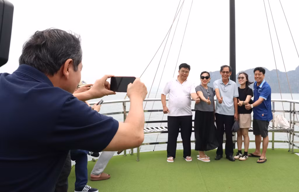 游客们兴致勃勃地在下龙湾合影留念。