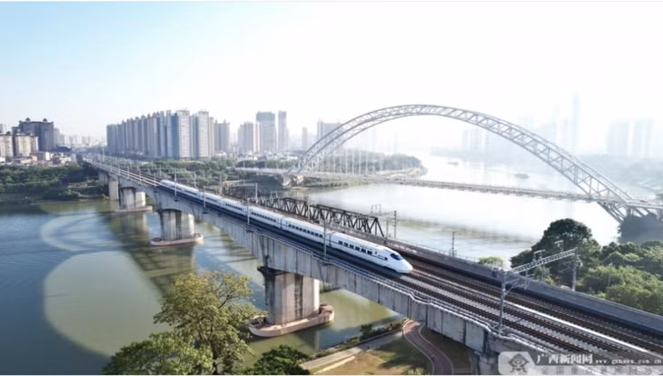 首趟试运行列车驶过永和大桥旁的南崇铁路线。 Chuyến tàu vận hành thử đầu tiên chạy qua tuyến đường sắt Nam Ninh - Sùng Tả cạnh cầu Vĩnh Hòa.