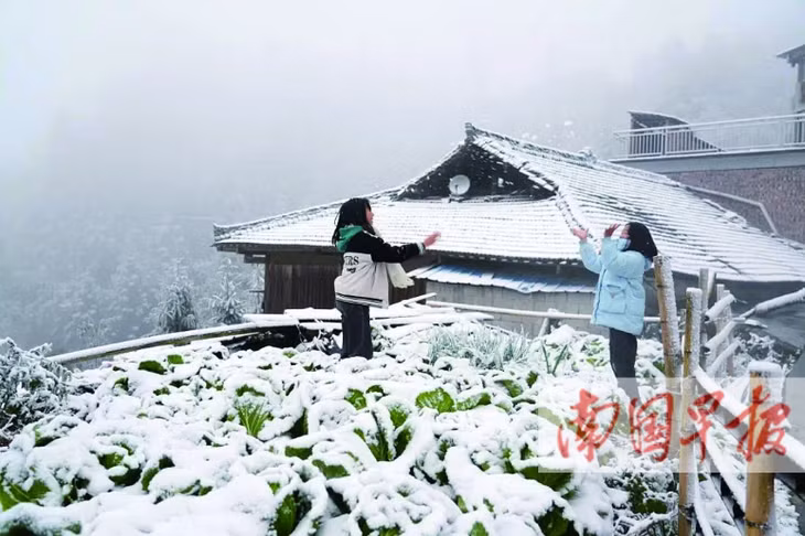 融水苗族自治县杆洞乡高强村，孩子们正在玩雪。梁强 摄 Trẻ em đang nghịch tuyết ở thôn Cao Cường, xã Can Động, huyện tự trị dân tộc Miêu Dung Thuỷ. (Ảnh: Lương Cường chụp)