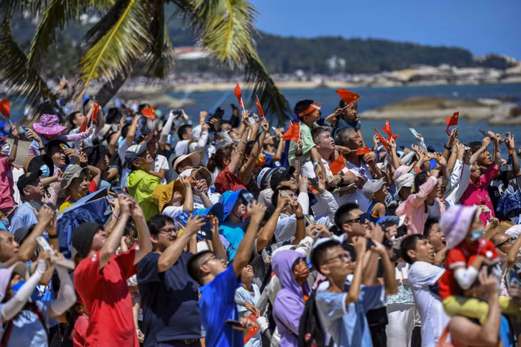 7月24日14时22分，搭载问天实验舱的长征五号B遥三运载火箭在中国文昌航天发射场点火发射，民众观看火箭点火升空（图/ CNSphoto） Vào lúc 14 giờ 22 phút ngày 24/7/2022, tên lửa đẩy Trường Chinh 5B - Y3 mang theo khoang thí nghiệm Vấn Thiên đã được phóng tại Trung tâm phóng vệ tinh Văn Xương, Trung Quốc, người dân xem tên lửa phóng lên không trung（Ảnh / CNSphoto）