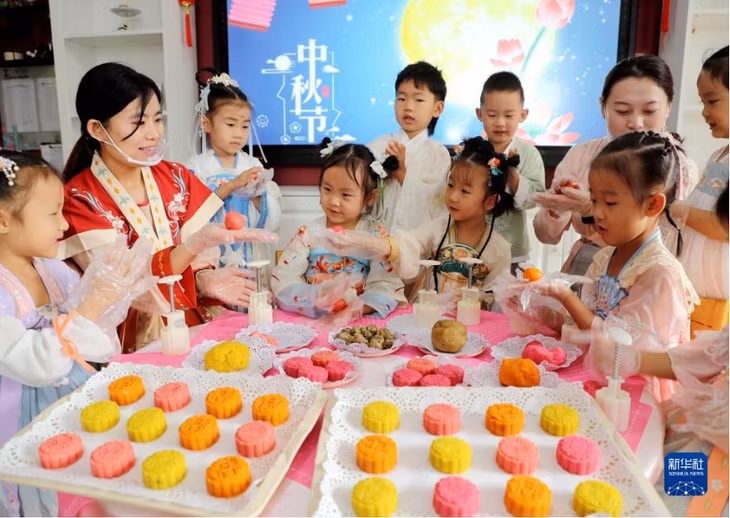 在山东省东营市东营区实验幼儿园，学生在老师的指导下体验制作月饼。刘智峰 摄 Tại Trường mẫu giáo Thực nghiệm quận Đông Doanh, thành phố Đông Doanh, tỉnh Sơn Đông, các em học sinh trải nghiệm làm bánh Trung thu dưới sự hướng dẫn của các thầy cô. Lưu Trí Phong chụp